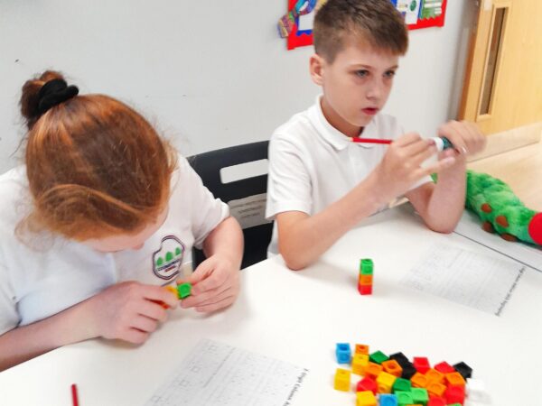 Learners at Coombswood School using cubes to support with their addition activities in Maths.