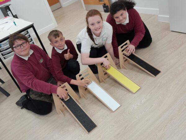 Learners at Coombswood SEN School in Dudley, engaging with a Science lesson exploring friction surfaces impacting on speed.