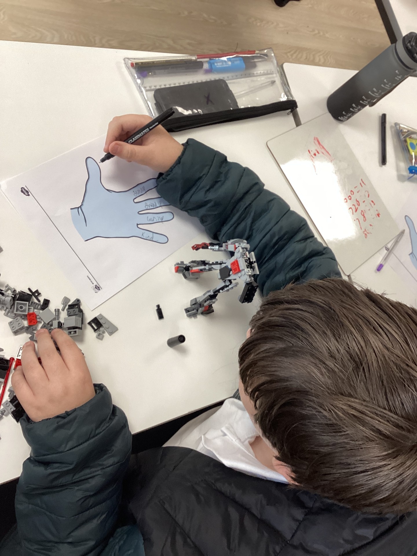 Learner contributing to the collaborative Good Friend Hand Wreath at Coombswood School to promote inclusivity and respect.